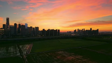 Aerial view of a high speed train travels on an elevated track past tall Stock Footage 341642826