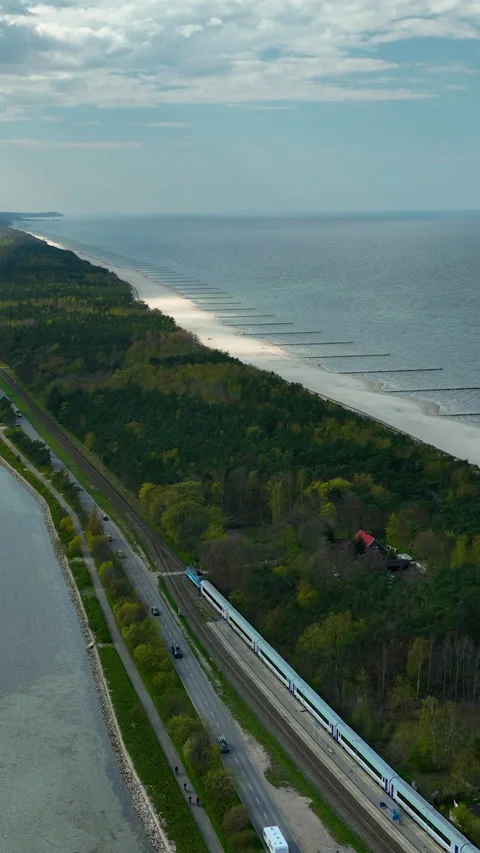 Aerial View Of High Speed Train Traveling Along Baltic Sea Coast Stock Footage 342251599