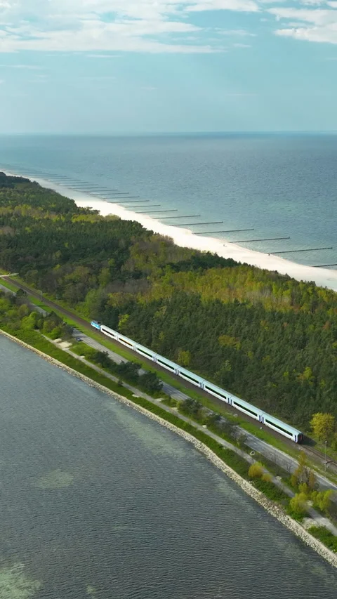 Aerial View Of High Speed Train Traveling Along Scenic Coastal Peninsula Stock Footage 342289375
