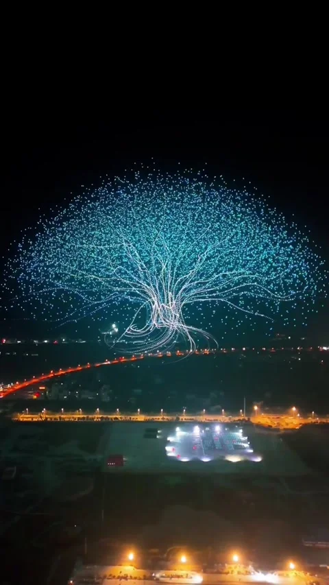 Aerial View of High-Tech Drone Light Show Forming a Giant Glowing Tree with Video stock 329006939