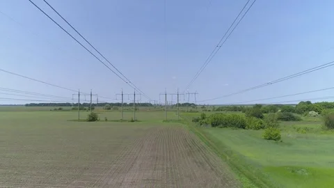 Aerial view. High-voltage electrical pylons  in the field Stock Footage 317913372