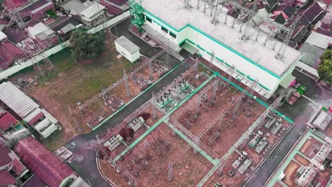 Aerial View of High Voltage Electrical Substation Surrounded by Urban Buildings Stock Footage 342664168