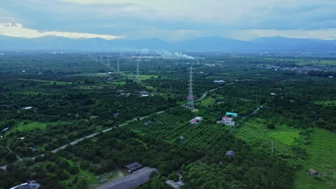 Aerial view of High voltage grid tower with wire cable at tree forest with fog Stock Footage 254787950