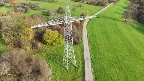 Aerial View of High Voltage Power Line Tower in Green Landscape Stock Footage 327973544