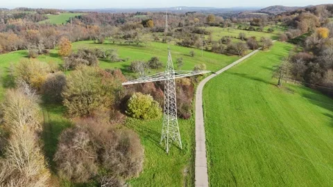 Aerial View of High Voltage Power Line Tower in Green Landscape Stock Footage 327974093