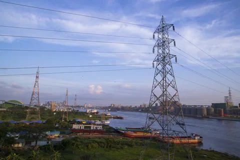 Aerial view of High voltage power line on the river and blue sky background.. Stock Photos