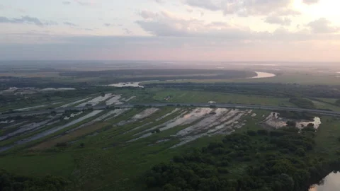 Aerial view of the highway across the river spill on the field Stock Footage 170714927