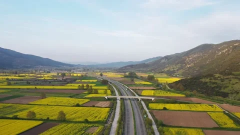 Aerial view of highway among fields at sunset. Stock Footage 132563641