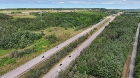 Aerial View of Highway Cutting Through Dense Forest Landscape Stock Footage 315828278