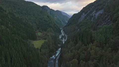 Aerial view of highway cutting through sunrise valley in Norway Stock Footage 320244725