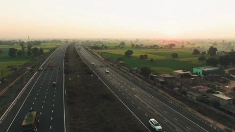 Aerial view of highway cutting through fields, India. Vídeos de archivo 325715844