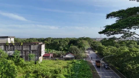 Aerial View of Highway with Fast Traffic Contrasting with Tropical Forest Stock Footage 334170385