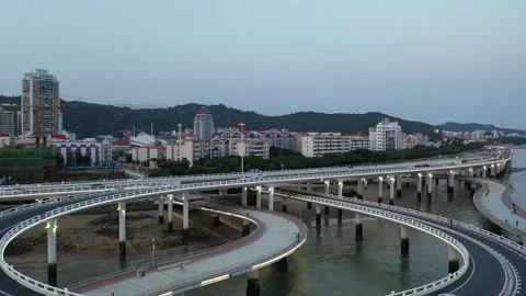 Aerial View of a Highway Interchange and Coastal City Stock Footage 345234485