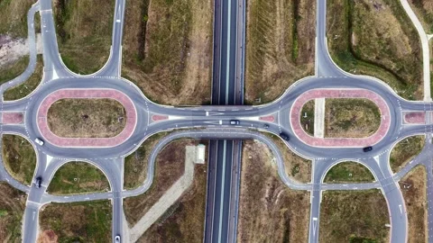Aerial view of a highway interchange with dual roundabouts in the Netherlands Stock Footage 345054429