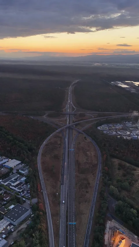 Aerial view of highway interchange at sunset in Sausheim, France. Stock Footage 344947332