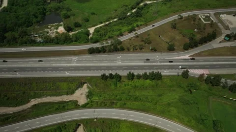 Aerial View of Highway Interchange Surrounded by Lush Green Landscape in Stock Footage 316446833
