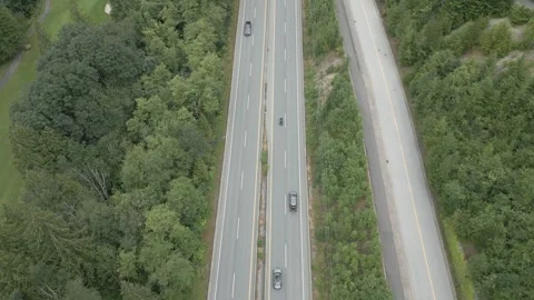 Aerial View of Highway Intersection Through Lush Green Forest Stock Footage 264325475