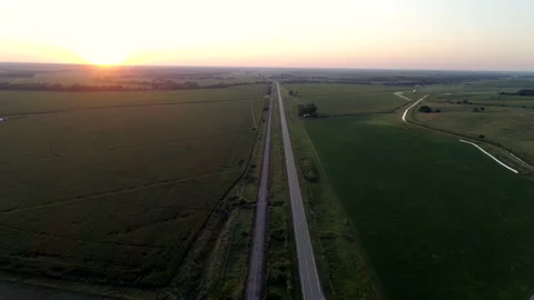 Aerial View of a Highway Nestled Into Nebraska Farmland at Sunset Stock Footage