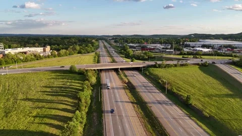 Aerial View of Highway Overpass and Interstate Traffic at Sunset 스톡 동영상 344782932
