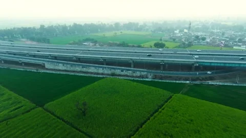 Aerial view of highway passing through fields, India. Stock Footage 325715841
