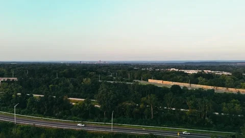 Aerial view of highway passing through dense forest... Stockbeeldmateriaal 340657934
