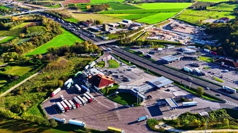 Aerial view of highway rest stop with parked trucks, Italy. Stock Footage 344982488