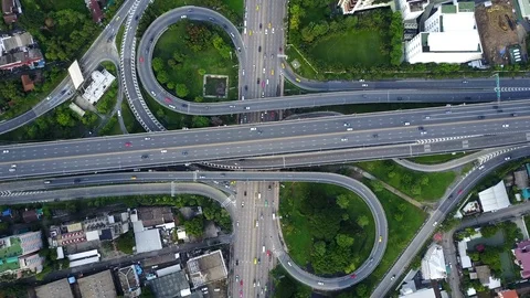 Aerial view of highway road interchange with busy urban traffic speeding Stock Footage 90803622