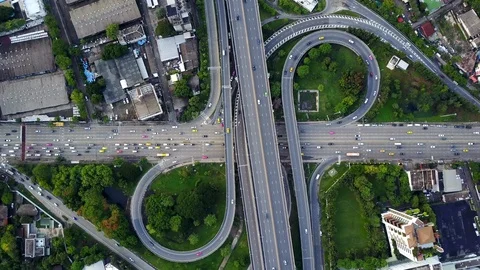 Aerial view of highway road interchange with busy urban traffic speeding Stock-Footage 90803653