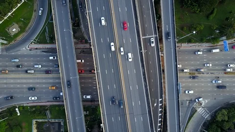 Aerial view of highway road interchange with busy urban traffic speeding Stock Footage 90803702