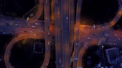 Aerial view of highway road interchange with busy car speeding at night Stock-Footage 90806326