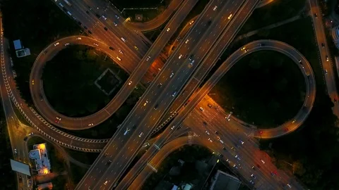 Aerial view of highway road interchange with busy car speeding at night Stock-Footage 90806782