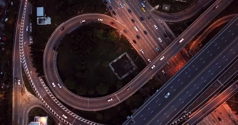 Aerial view of highway road interchange with busy car speeding at night Stock-Footage 90983689