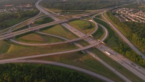 Aerial view of a highway stack interchange at sunset Vídeo Stock 347734740