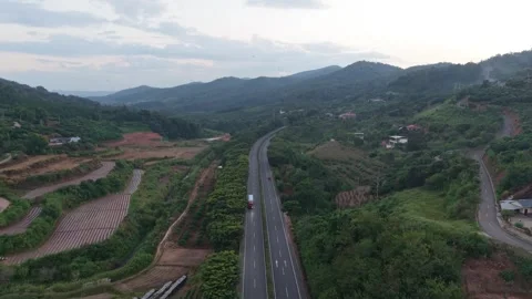 Aerial View of Highway Stretching Through Lush Mountain Valley Stock-Footage 311279197