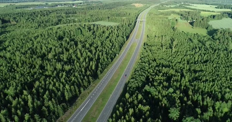 Aerial view of highway through fields and forests with cars. Stock Footage 140619788