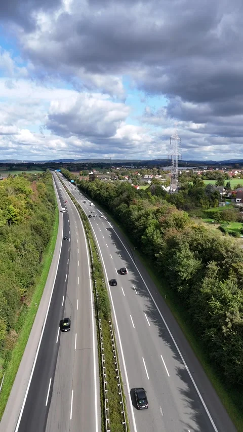 Aerial View of Highway Through Green Countryside with Power Lines 스톡 동영상 346887136