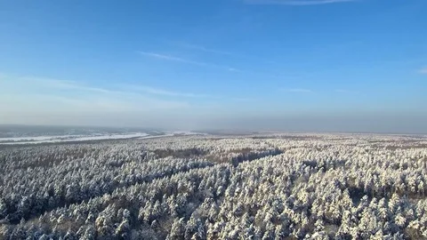 Aerial view on highway thru winter forest and field. Frozen river on background  Stock Footage 101656824