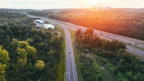 Aerial view of highway traffic moving through forest... Video stock 340657935