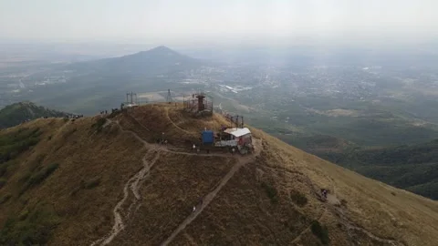 Aerial view of hikers and structures on the summit of Beshtau mountain Stock Footage 338009486
