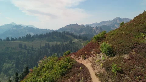 Aerial View of Hikers on Hillside Backpacking Trail, Mountains in Background Stock Footage 224764675