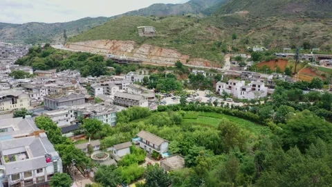 Aerial view of hillside lakeside ancient village mountain forest panorama in Stock Footage 337922875