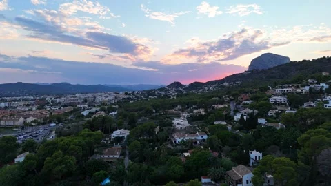 Aerial view of hillside town below Montgo mountain at sunset, Javea, Spain Stock Footage 339989473