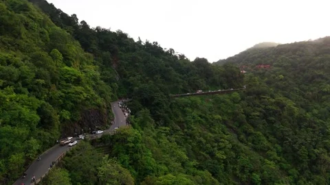 Aerial View of Hilly Roads Through Lush Green Mountains with Dense Forest Stock Footage 341310234