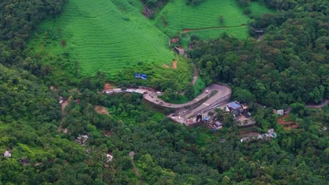 Aerial View of Hilly Roads Through Lush Green Mountains with Dense Forest Stock Footage 341310287