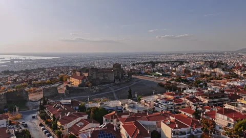 Aerial view of a historic castle overlooking modern Greek cityscape Stock Footage 294792203