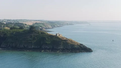Aerial view of the historic Corps de Garde de Dahouet perched on a rocky Stock Footage 346692933