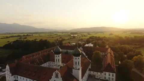 Aerial view of a historic monastery and surrounding village in a green valley Stock Footage 289625865