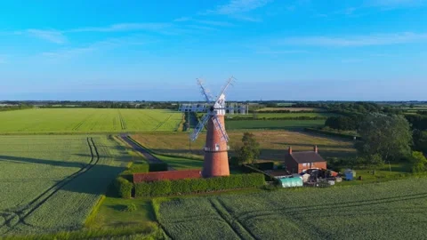 Aerial view of historic windmill amid green fields Видео 342610964
