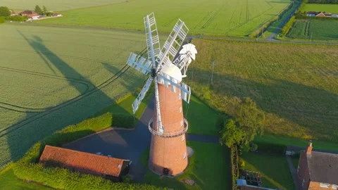 Aerial view of historic windmill in green countryside Видео 342614809