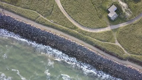 Aerial view a holiday home at the sea and grassy coast near Lønstrup, Denmark Stock Footage